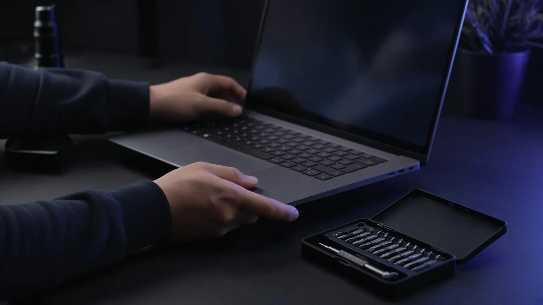 Hands on a laptop next to a precision toolkit, ready for website repair